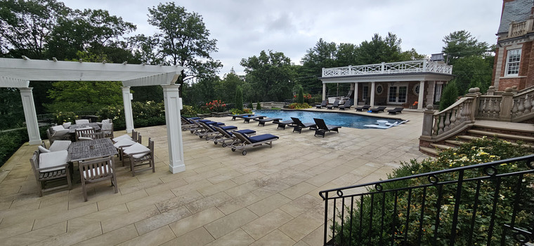 Grand estate pool with pergola dining area and balustrade terrace